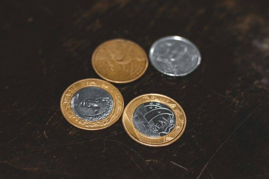 moedas de prata e ouro em uma superfície preta.